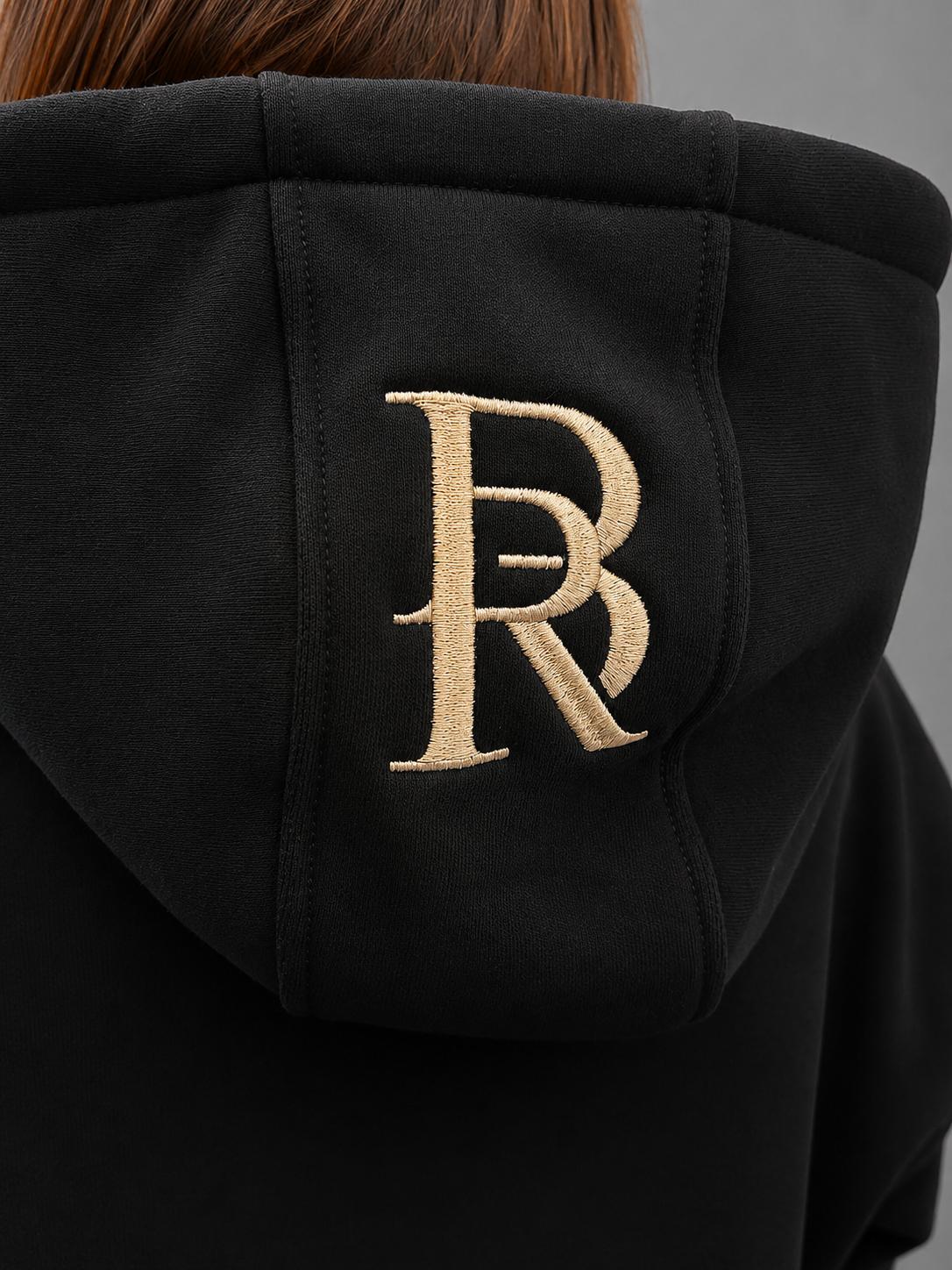 Broderie BR sur la capuche de l'Ensemble Élite 2026 noir BRYLON PARIS